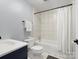 Clean bathroom featuring a shower-tub combo with white tile, a vanity sink, and neutral-colored walls at 512 Secrest Ave, Belmont, NC 28012
