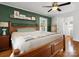 This bedroom features a dark green accent wall and a bed with a decorative bedspread at 512 Secrest Ave, Belmont, NC 28012