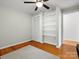 Spacious bedroom featuring hardwood floors, closet, and ample storage space with built-in shelving at 512 Secrest Ave, Belmont, NC 28012
