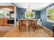 Dining room with blue walls, bench seating and access to kitchen at 512 Secrest Ave, Belmont, NC 28012