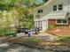 View of the home's exterior with a trailer and a basketball hoop next to a brick accent wall at 512 Secrest Ave, Belmont, NC 28012