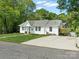 Quaint white home with a well-manicured lawn and a convenient driveway at 512 Secrest Ave, Belmont, NC 28012