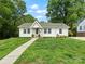 Charming single-story home with white siding, well-maintained lawn and inviting walkway at 512 Secrest Ave, Belmont, NC 28012
