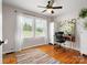 Bright home office with natural light, hardwood floors, desk, and colorful area rug at 512 Secrest Ave, Belmont, NC 28012