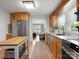 Open kitchen with stainless steel appliances, hardwood floors and view to living room at 512 Secrest Ave, Belmont, NC 28012