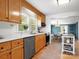 A cozy kitchen featuring wooden cabinets, modern appliances, and a view into the dining area at 512 Secrest Ave, Belmont, NC 28012