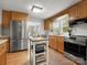 Spacious kitchen with stainless steel appliances, island and hardwood floors at 512 Secrest Ave, Belmont, NC 28012