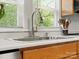 Bright kitchen sink area with stainless steel faucet and a view of the outdoors from the window at 512 Secrest Ave, Belmont, NC 28012