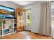 Bright living room featuring hardwood floors, a charming front door, and custom-built shelving at 512 Secrest Ave, Belmont, NC 28012