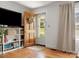 Bright living room featuring hardwood floors, a charming front door, and custom-built shelving at 512 Secrest Ave, Belmont, NC 28012