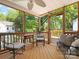 Relaxing screened porch with comfortable seating and view of wooded area at 512 Secrest Ave, Belmont, NC 28012