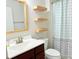 Bathroom with a dark wood vanity and modern sink. Floating shelves are mounted above the toilet at 531 Cherry Blossom Nw Ave, Concord, NC 28027
