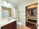 Well-lit bathroom featuring a modern vanity with storage, a toilet, and a glimpse of a walk-in shower at 531 Cherry Blossom Nw Ave, Concord, NC 28027