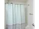 Bathroom featuring a turquoise and white polka dot shower curtain and tiled shower at 531 Cherry Blossom Nw Ave, Concord, NC 28027