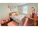 Charming bedroom with a comfortable bed, plush pink rug and bright natural light at 531 Cherry Blossom Nw Ave, Concord, NC 28027