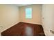 Bright, empty bedroom with wood floors and natural light from a single window at 531 Cherry Blossom Nw Ave, Concord, NC 28027