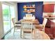 Bright dining area featuring a square table and large window, with the kitchen in the background at 531 Cherry Blossom Nw Ave, Concord, NC 28027