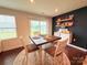 Bright dining area with large window and dark accent wall with decor shelves, creating a cozy atmosphere at 531 Cherry Blossom Nw Ave, Concord, NC 28027