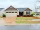 Charming single-story home with manicured lawn and attached two-car garage at 531 Cherry Blossom Nw Ave, Concord, NC 28027