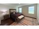 Spacious main bedroom with a comfortable bed, natural light, and a decorative trunk at the foot of the bed at 531 Cherry Blossom Nw Ave, Concord, NC 28027