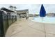 Community pool area with shaded seating and ample space for lounging near the clear water at 531 Cherry Blossom Nw Ave, Concord, NC 28027