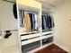 Organized walk-in closet with shelving, hanging rods, and drawers for efficient storage and wardrobe management at 531 Cherry Blossom Nw Ave, Concord, NC 28027
