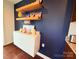 Close-up on a dark accent wall featuring decorative shelves and a white cabinet, adding a personal touch at 531 Cherry Blossom Nw Ave, Concord, NC 28027