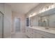Bathroom featuring double vanity, white cabinets and large mirror with decorative lighting at 5604 Unionville Rd, Monroe, NC 28110