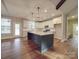 Spacious kitchen features a center island, white cabinets and stainless steel appliances at 5604 Unionville Rd, Monroe, NC 28110