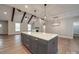 Open kitchen features white cabinetry, stainless steel appliances, and a central island at 5604 Unionville Rd, Monroe, NC 28110