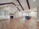 Open living area featuring exposed ceiling beams, hardwood floors, fireplace and kitchen island at 5604 Unionville Rd, Monroe, NC 28110