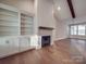Open living area showcasing fireplace with built-in shelving and wood mantle at 5604 Unionville Rd, Monroe, NC 28110
