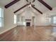Open living area featuring fireplace, windows and exposed ceiling beams at 5604 Unionville Rd, Monroe, NC 28110