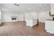 Spacious open concept living room flowing into the kitchen area and featuring a modern fireplace at 561 Mountain View Dr, Monroe, NC 28110