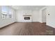 Open-concept living room featuring modern fireplace and neutral color palette at 561 Mountain View Dr, Monroe, NC 28110