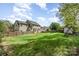 Large backyard featuring grass, fence, and playset at 591 Highland Ridge Rd, Mooresville, NC 28115