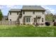 Home backyard featuring a patio with seating, grill, and fencing at 591 Highland Ridge Rd, Mooresville, NC 28115