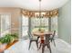 Inviting breakfast nook with floral valances, tile flooring, and round table at 591 Highland Ridge Rd, Mooresville, NC 28115