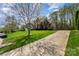 Well-maintained yard with long driveway and a basketball hoop leading up to the brick home at 591 Highland Ridge Rd, Mooresville, NC 28115
