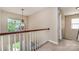 Foyer featuring a decorative chandelier, wood railing and sunlight streaming through a large window at 591 Highland Ridge Rd, Mooresville, NC 28115