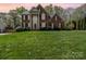 Traditional brick home with well-maintained lawn, blue shutters and mature trees at 591 Highland Ridge Rd, Mooresville, NC 28115