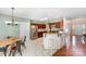 Spacious kitchen featuring dark cabinets, stainless appliances, breakfast bar, and tile floors at 591 Highland Ridge Rd, Mooresville, NC 28115