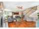 Open-concept living room with fireplace, staircase, and hardwood floors leading to kitchen at 591 Highland Ridge Rd, Mooresville, NC 28115