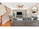 Cozy living room featuring a fireplace, staircase, and hardwood floors at 591 Highland Ridge Rd, Mooresville, NC 28115