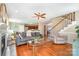 Open-concept living room with fireplace, staircase, and hardwood floors leading to kitchen at 591 Highland Ridge Rd, Mooresville, NC 28115