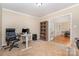 Well-lit office features a large bookshelf, white desk, and comfortable black office chair at 591 Highland Ridge Rd, Mooresville, NC 28115