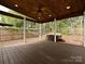 This covered wooden deck with a hot tub and hammock is great for entertaining at 6112 Swanston Dr, Charlotte, NC 28269