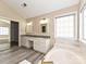 Bright primary bathroom features a double vanity, bathtub, and a large walk-in closet at 6112 Swanston Dr, Charlotte, NC 28269