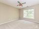 This comfortable bedroom features a ceiling fan and a large window for natural light at 6112 Swanston Dr, Charlotte, NC 28269