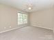 This comfortable bedroom features a ceiling fan and a large window for natural light at 6112 Swanston Dr, Charlotte, NC 28269